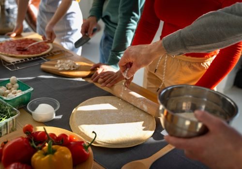 high-angle-family-cooking-delicious-pizza-scaled.jpg